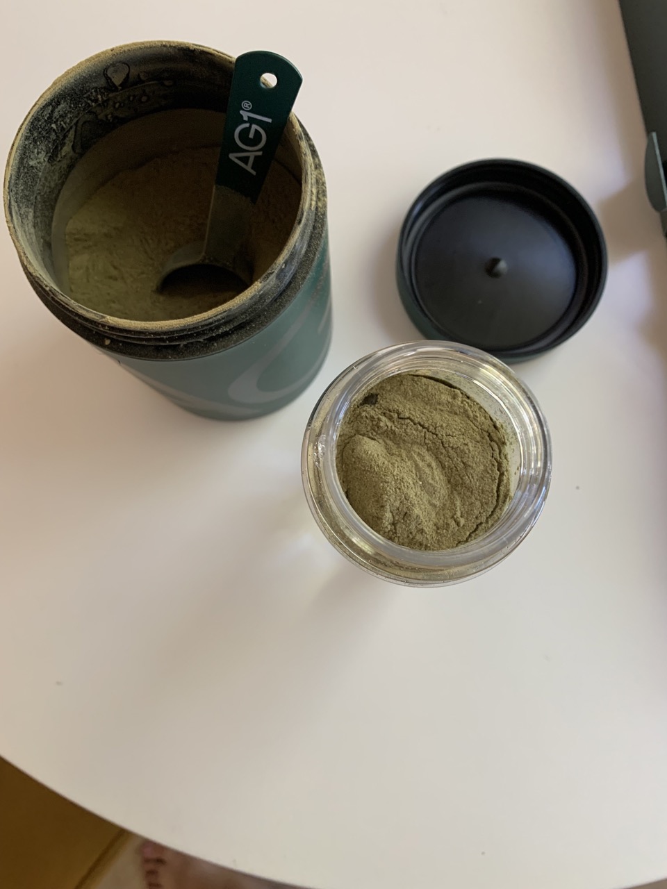 An image of the open product with a scoop in the canister. 