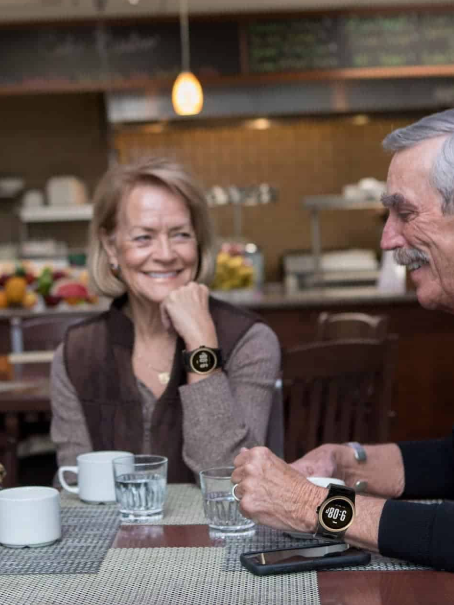 Two seniors at lunch wearing Kanega Watches