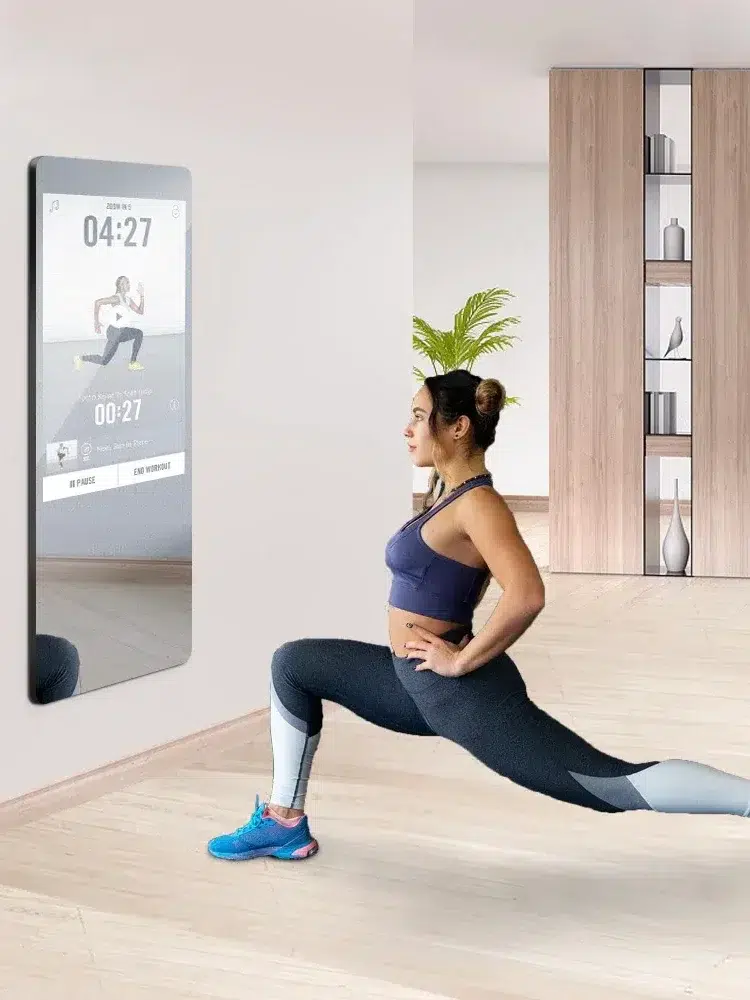 A model lunging in front of a workout on an Aquadom smart mirror