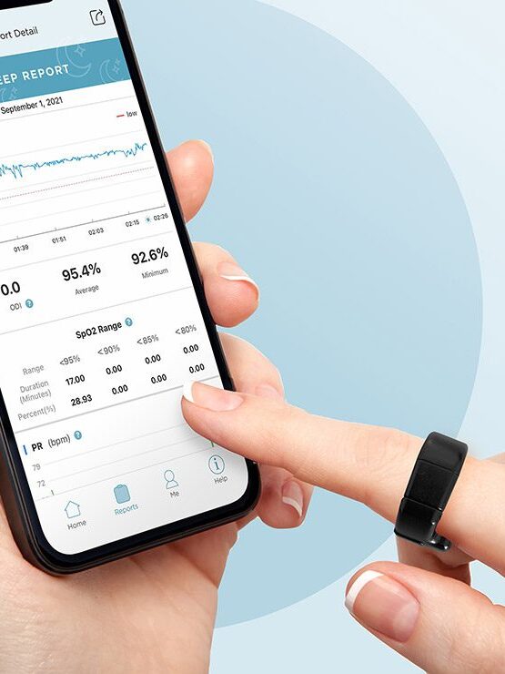 A hand using a smartphone app wearing a Bodimetrics Prevention Circul+ ring