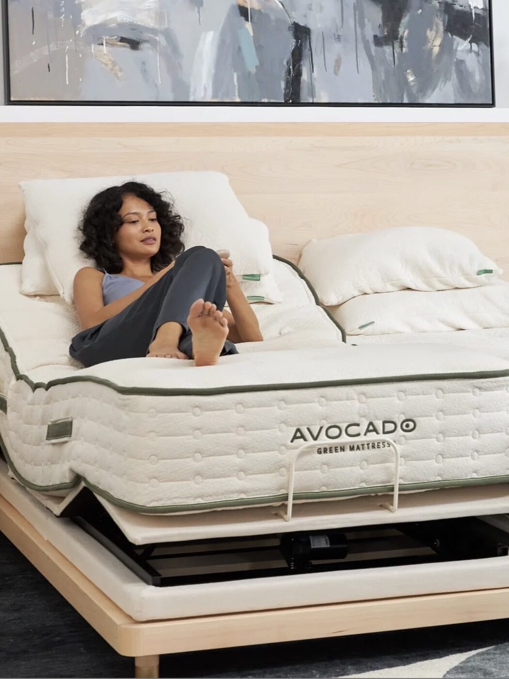 A model relaxes on an Avocado Green Mattress