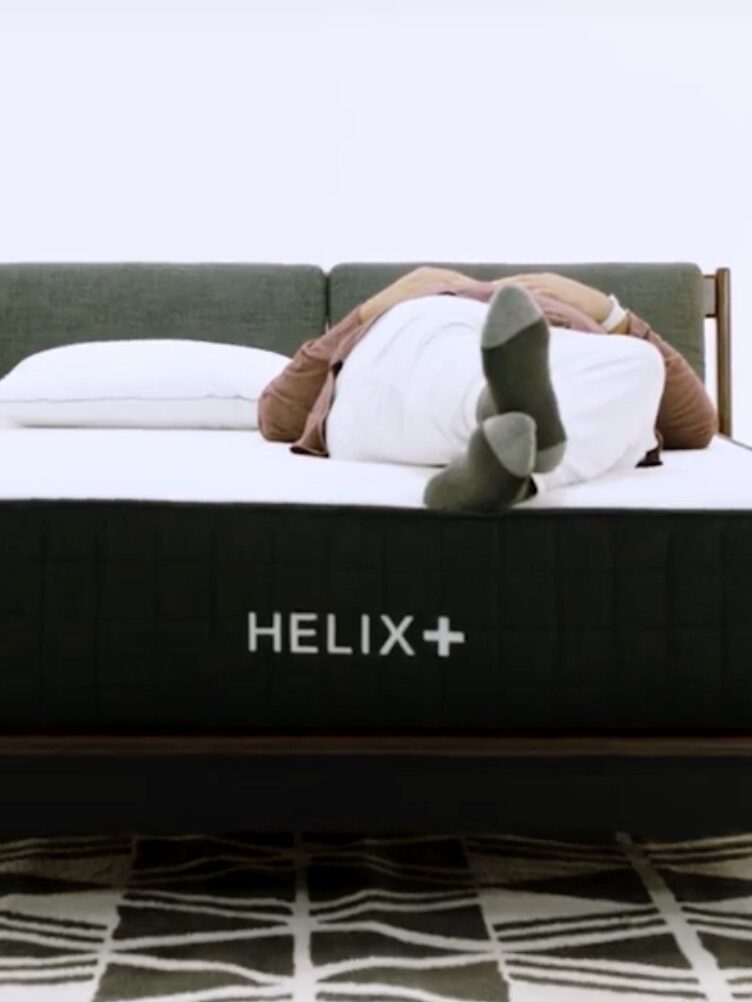 A model lies on a Helix Plus Mattress