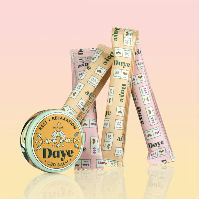Daye CBD Balm and packaged tampons on a gradient yellow and pink background