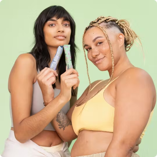 Two models pose holding Daye CBD tampons and smiling