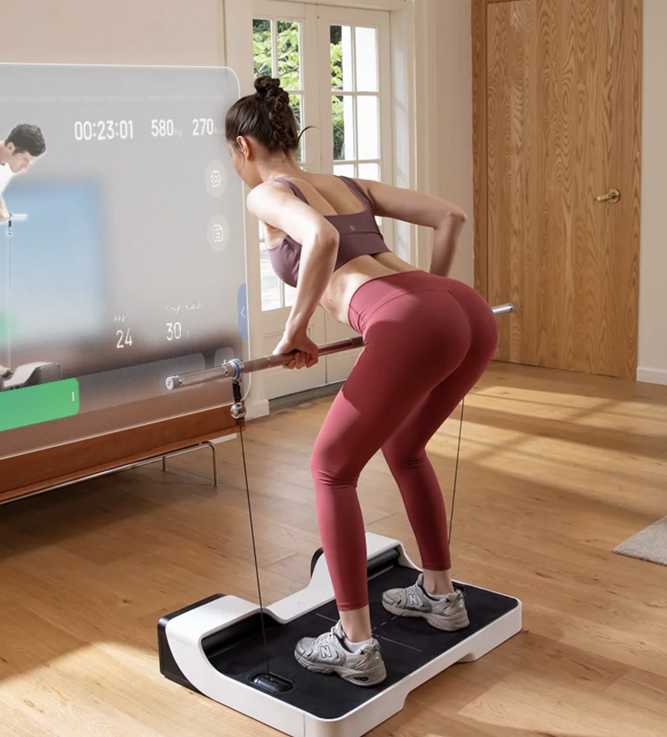 Woman exercising with a smart fitness machine at home.
