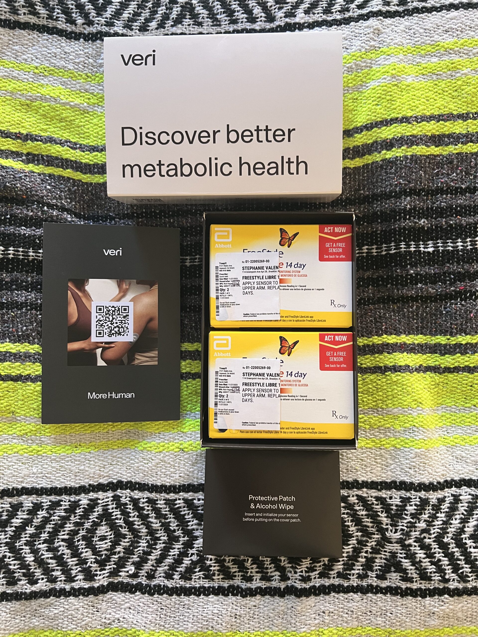 An array of veri continuous glucose monitoring system components and packaging with a promotional card stating "discover better metabolic health.