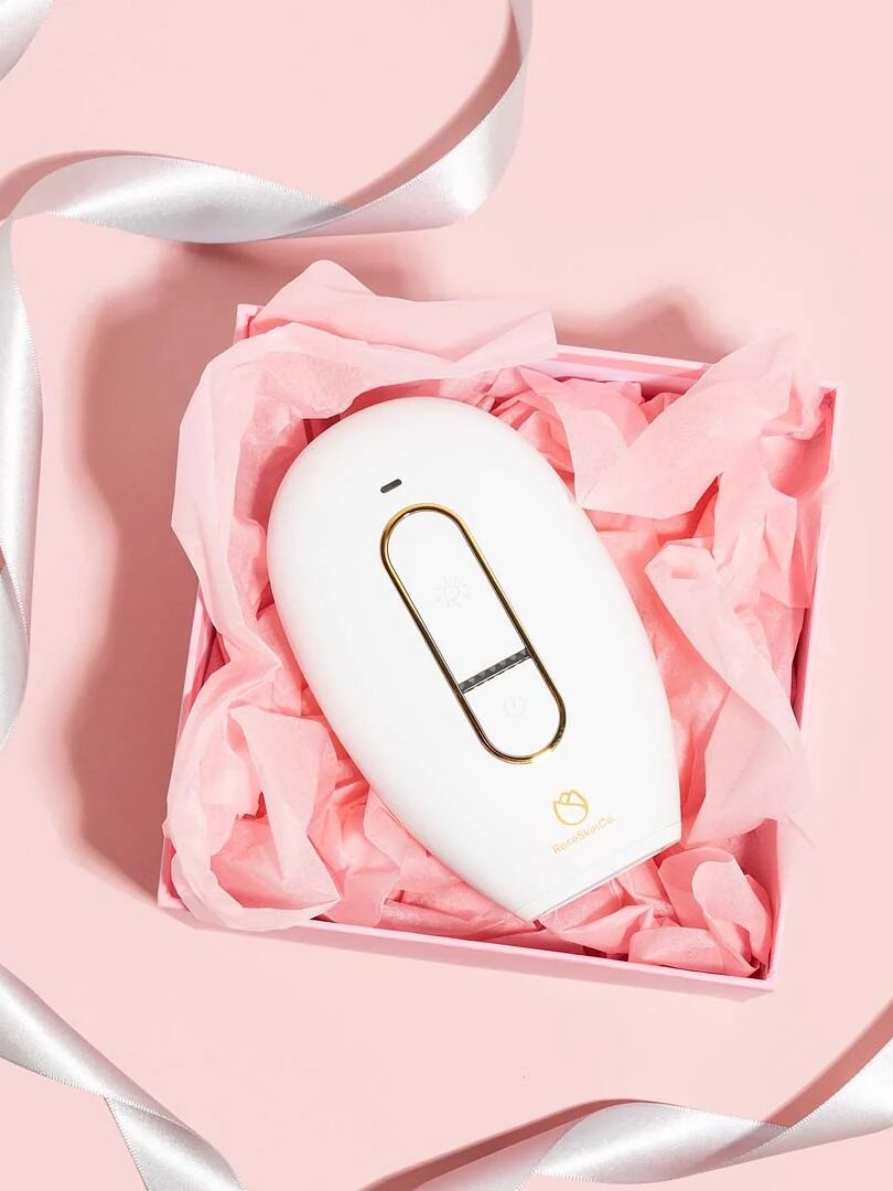 A pink box with a laser hair removal device from Lumi in it.