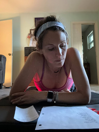 A focused woman reviewing papers at a table.