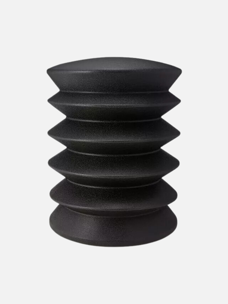 Black, ribbed, cylindrical seat with a tapered design, isolated on a white background.