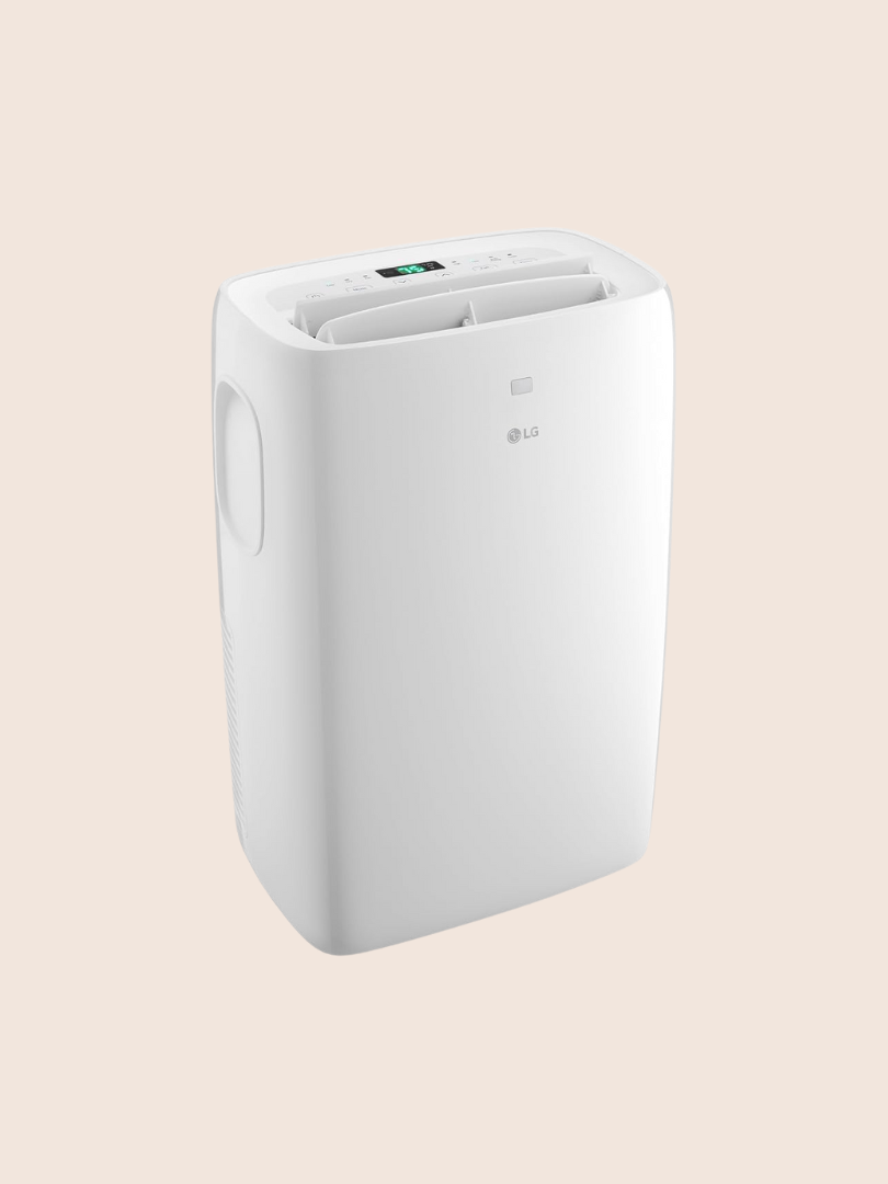 A white LG portable air conditioner with a digital display and top air vents, shown against a plain light background, pairs well in any space alongside small wellness devices like massage guns.