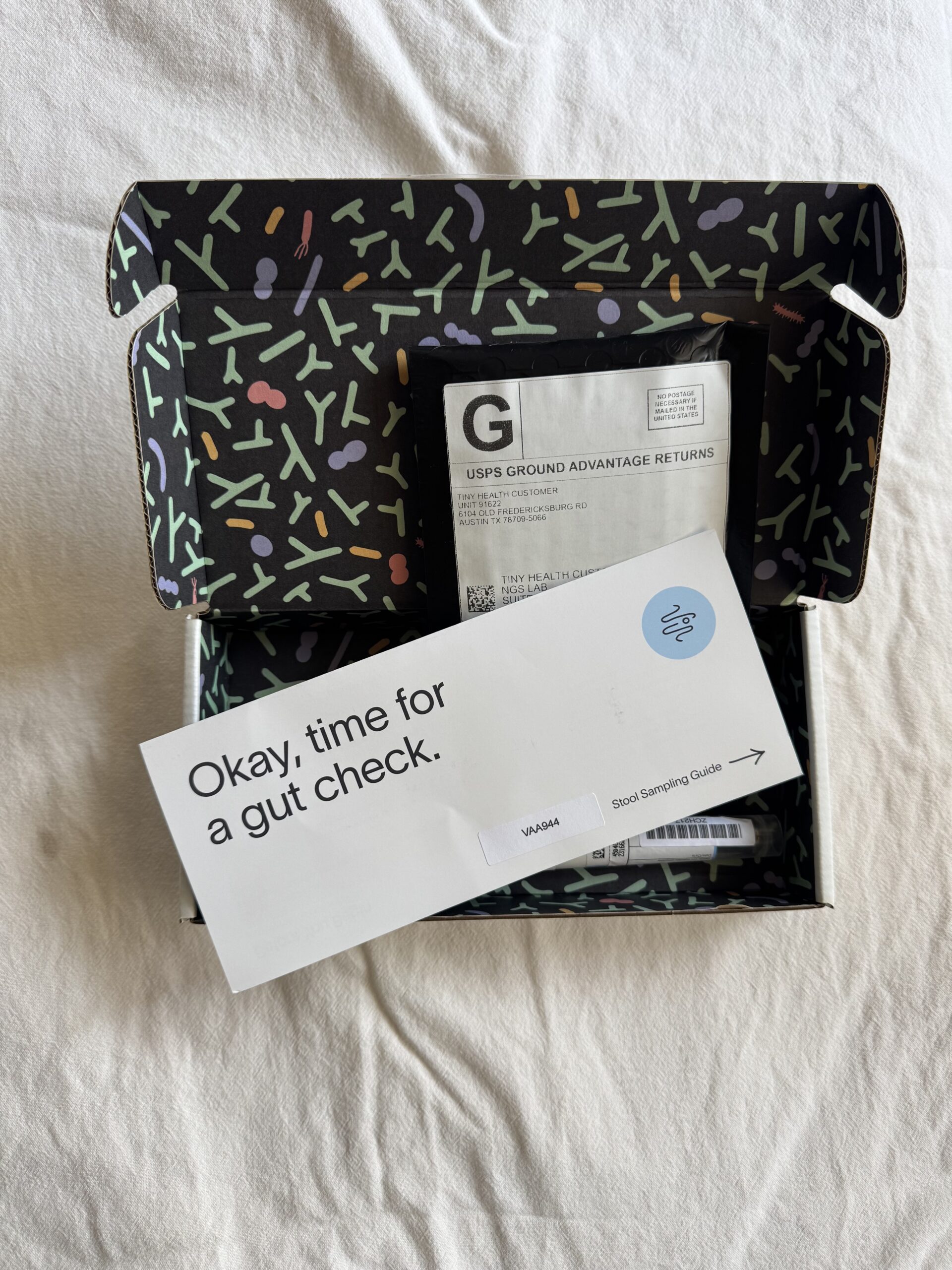 An open box with a return shipping label and a card that reads, "Okay, time for a gut check." The interior of the box has a colorful pattern.