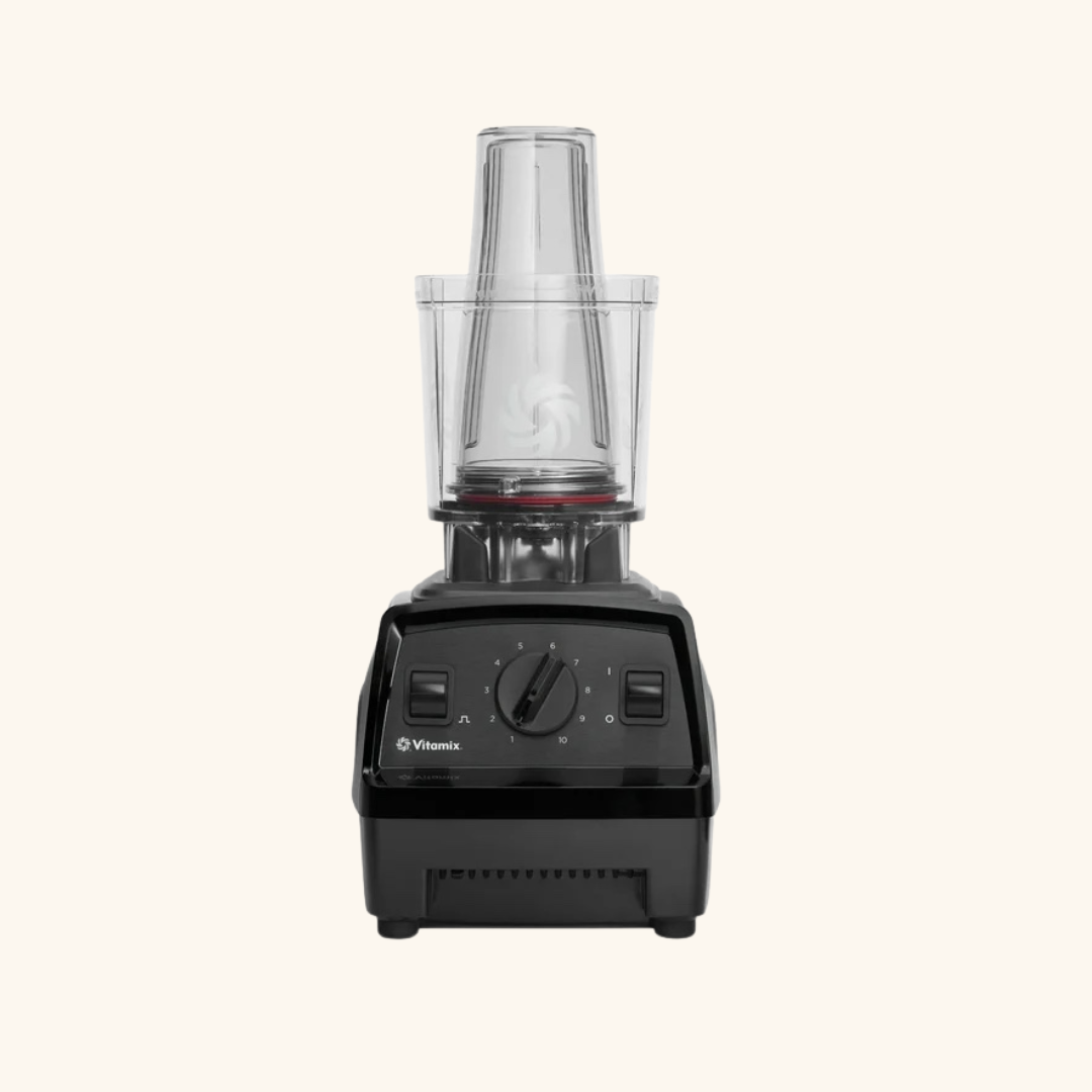 A black Vitamix food processor with a clear plastic container and lid, shown against a plain, light background—perfect for healthy meal prep after intense workouts with massage guns.