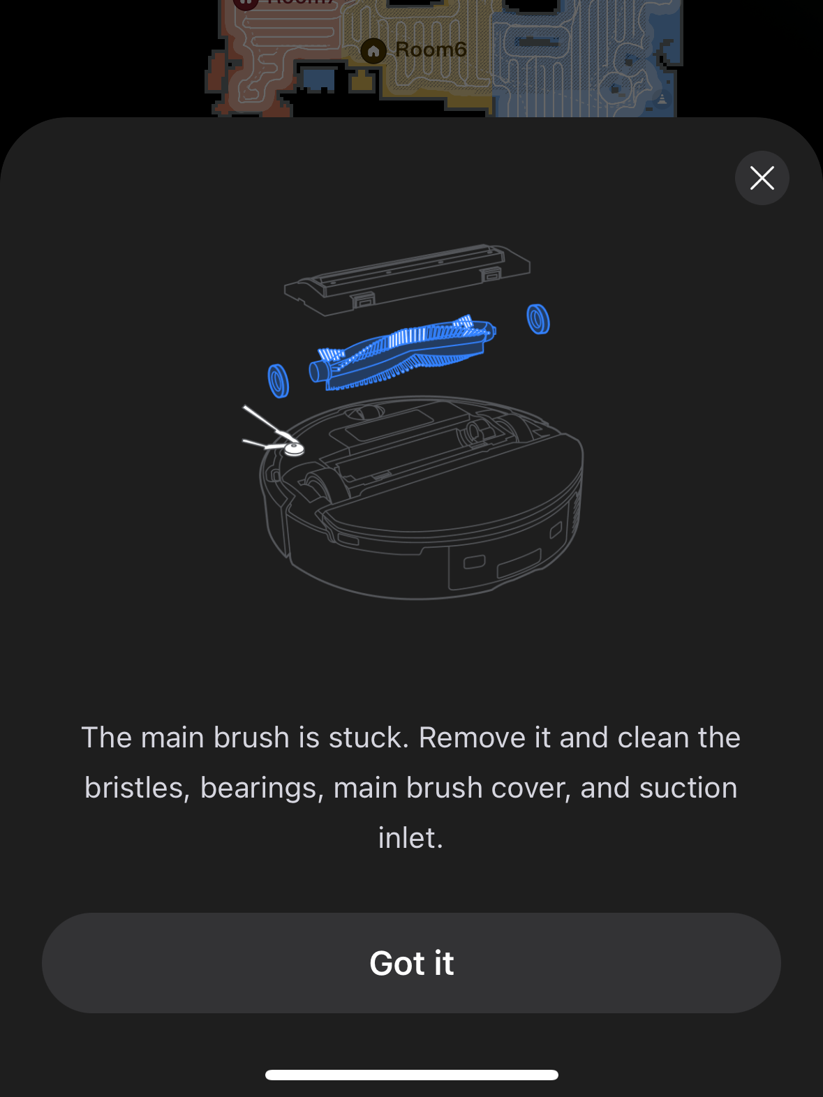 Robot vacuum app screen showing a notification that the main brush is stuck, with instructions to remove and clean the brush, cover, and suction inlet.