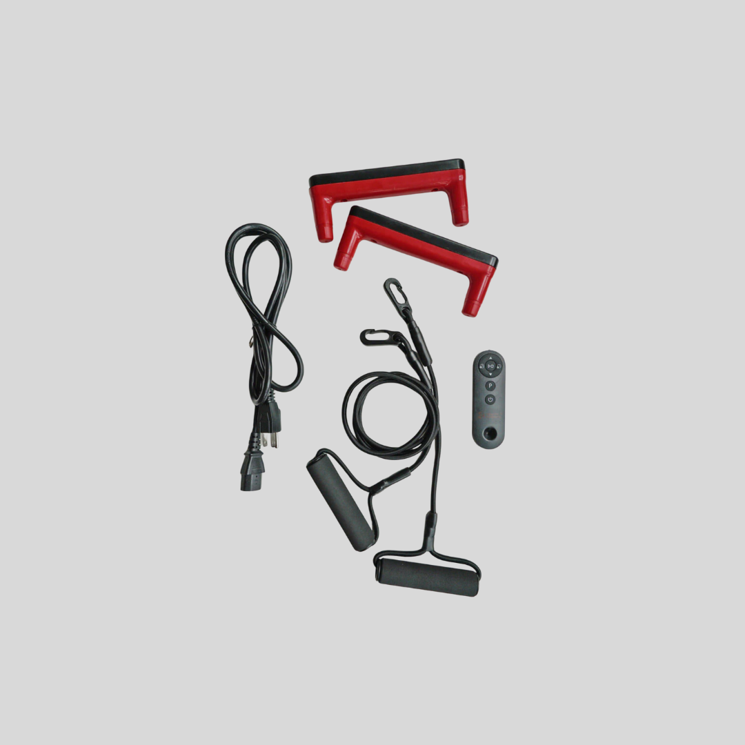 Red and black fitness handles, a coiled black cable, a power cable, and a small remote—perfect accessories for massage guns—are neatly arranged on a plain gray background.