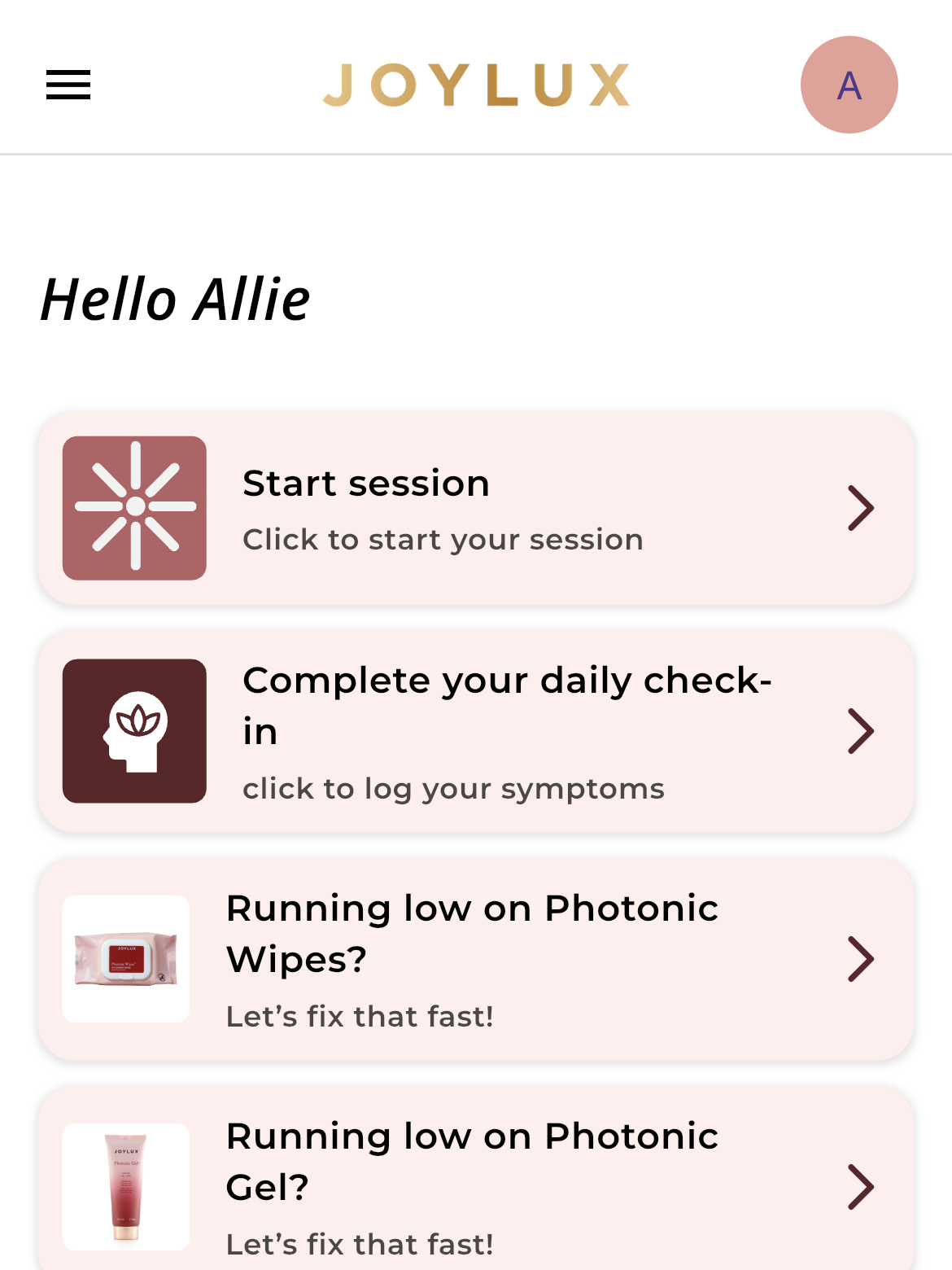 Mobile app dashboard for Joylux showing session start, daily check-in, low supply alerts for Photonic Wipes and Gel, and a featured article with a photo of two people by the water.