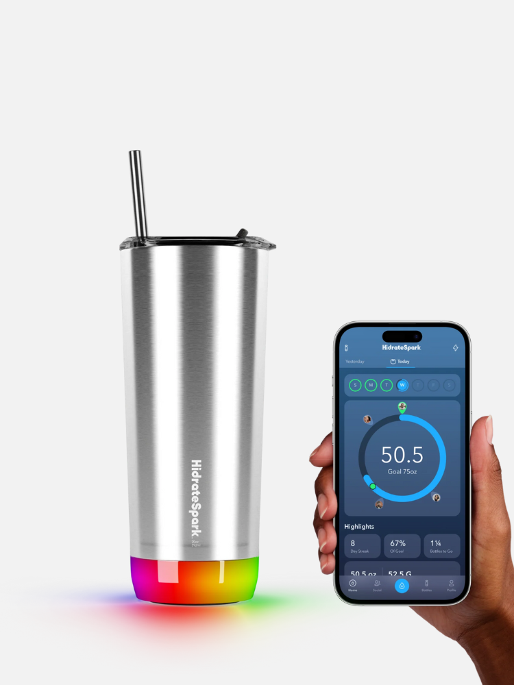 A stainless steel smart tumbler with a glowing base is shown next to a hand holding a smartphone displaying a hydration tracking app, highlighting the innovative features of smart waterbottles.
