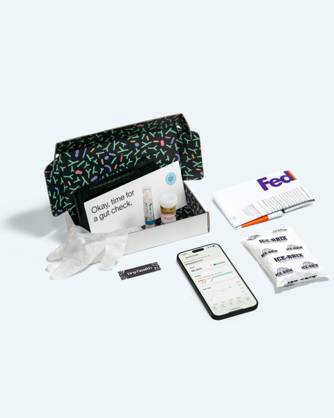 An open testing kit box with gloves, vials, card, FedEx envelope, ice packs, a smartphone displaying health data, and massage guns on a white background.