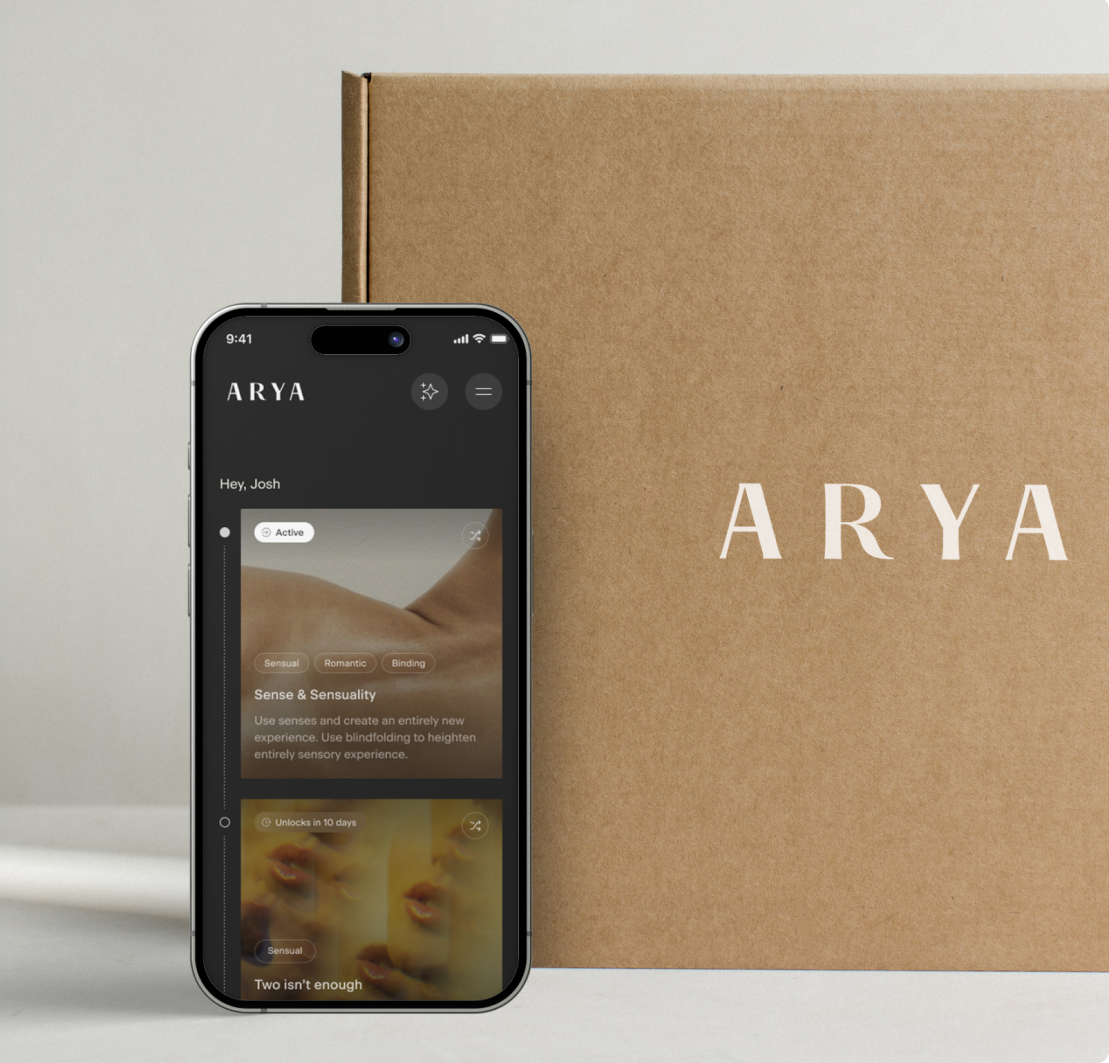 A smartphone displaying the ARYA app is positioned in front of a brown box with the ARYA logo, highlighting their innovative range of massage guns.